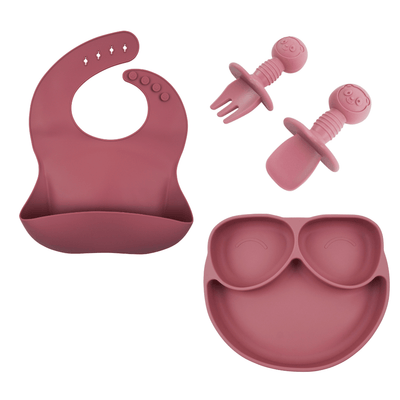Pink silicone plate, bib and utensils.